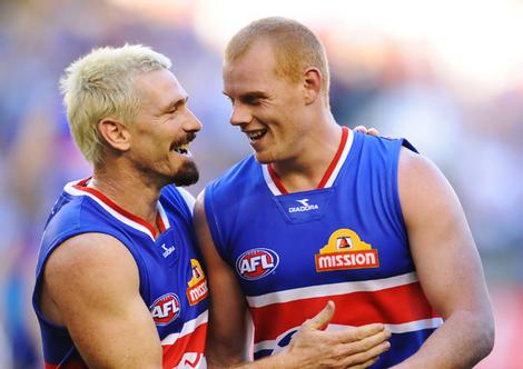 Jason Akermanis, left, celebrates a win with teammate Adam Cooney in this photo by Vince Caligiuri from The Age.Com