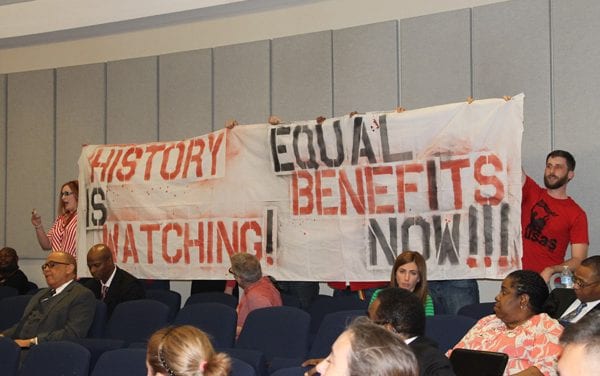 LGBT advocates rally in red at DART board meeting to demand DP benefits